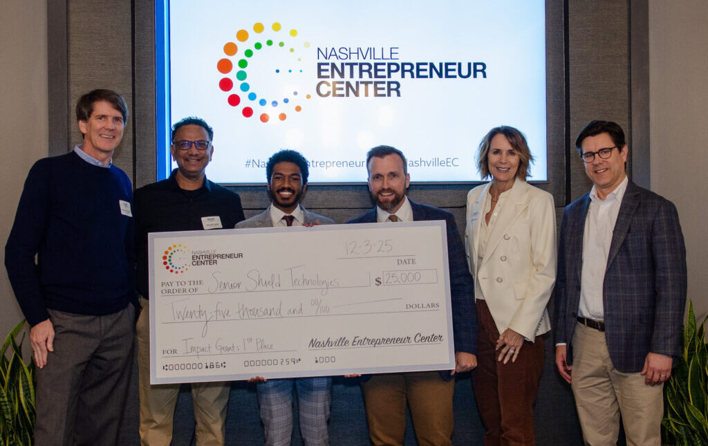 Recipients pose with a ceremonial check at the Nashville Entrepreneur Center following an Impact Grants award.