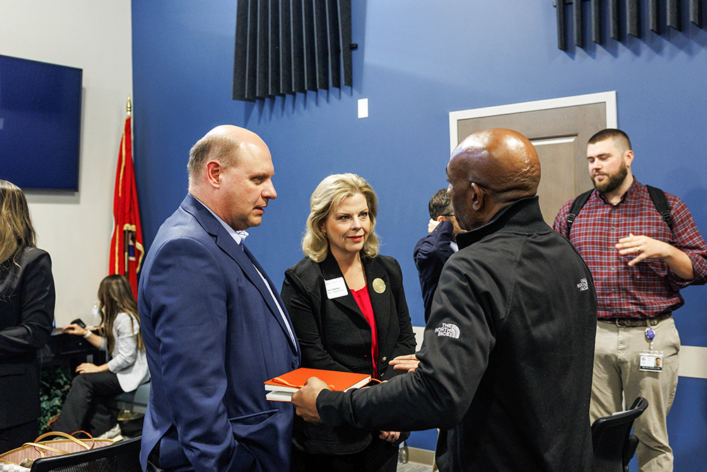 Participants continue conversations following presentations at the inaugural Civic Tech Jam, discussing potential collaborations between Metro departments and university researchers.
